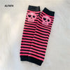 A pair of black and pink striped fingerless socks featuring skull designs for Y2K grunge accessories.