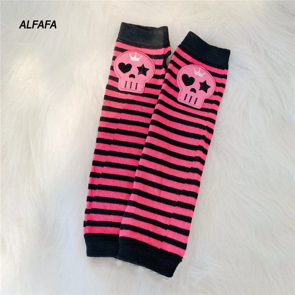 A pair of black and pink striped fingerless socks featuring skull designs for Y2K grunge accessories.