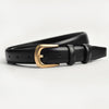 Black leather belt with a gold-toned buckle lying on a white surface.