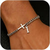 A close-up of a personalized stainless steel cross Cuban chain bracelet worn on a wrist.