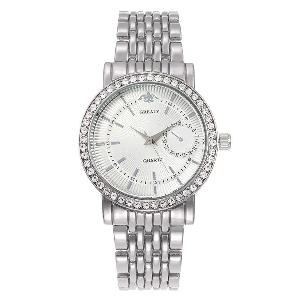A silver tone quartz wristwatch with a crystal face and metal link bracelet.