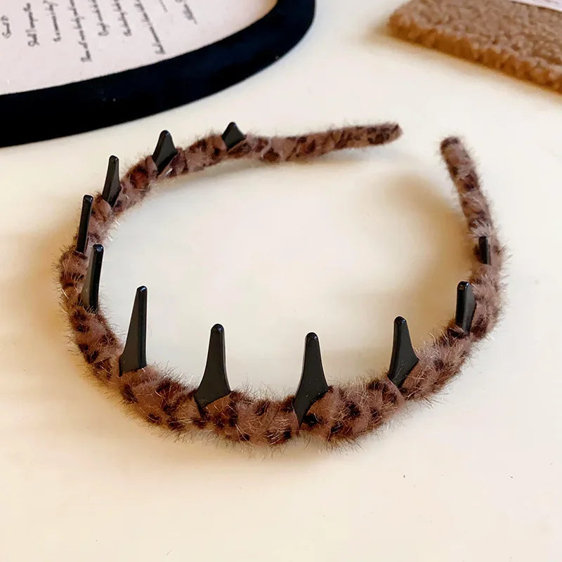 A brown resin wave toothed headband for women with a fuzzy texture displayed on a white background.