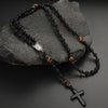 Black obsidian and tiger's eye beads on a string with a silver cross pendant necklace