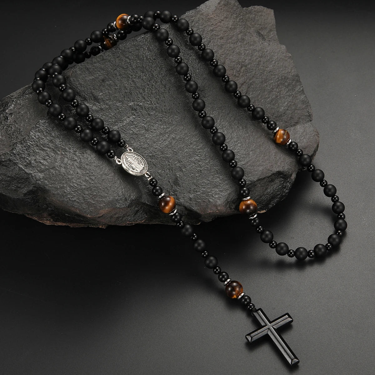 Black obsidian and tiger's eye beads on a string with a silver cross pendant necklace
