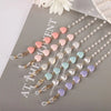 Multiple strands of fashion pearl beaded eyewear chains featuring pink, white, and blue colored beads