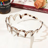 A set of fashion acetate toothed headbands in a marbled brown and cream pattern displayed on a white surface.