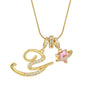 Gold letter pendant necklace featuring a stylized 'Y' design and a pink gemstone charm