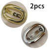Two gold-colored metal oval hair clips shown in close-up view.