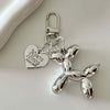Silver heart-shaped cartoon dog keychain with a clasp and chain