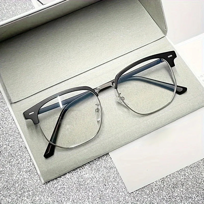 A pair of retro half gold frame anti blue light eyewear resting in a silver box.