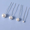Eightteen faux pearl hair pins with silver wires displayed on a light blue background.