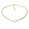 A delicate necklace made of mother of pearl beads with crystal accents and a gold-colored chain.