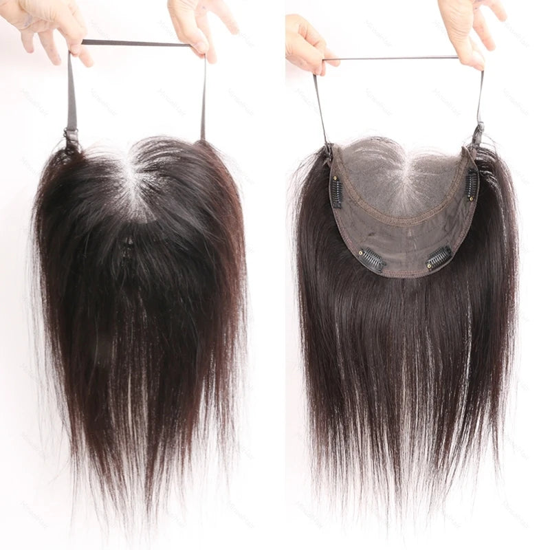 A pair of lace front hair toppers being held above a person's forehead.
