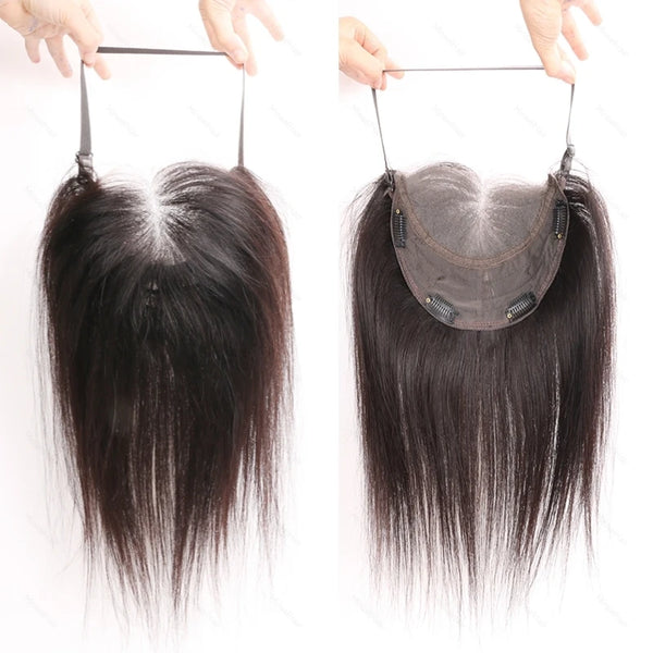 A pair of lace front hair toppers being held above a person's forehead.