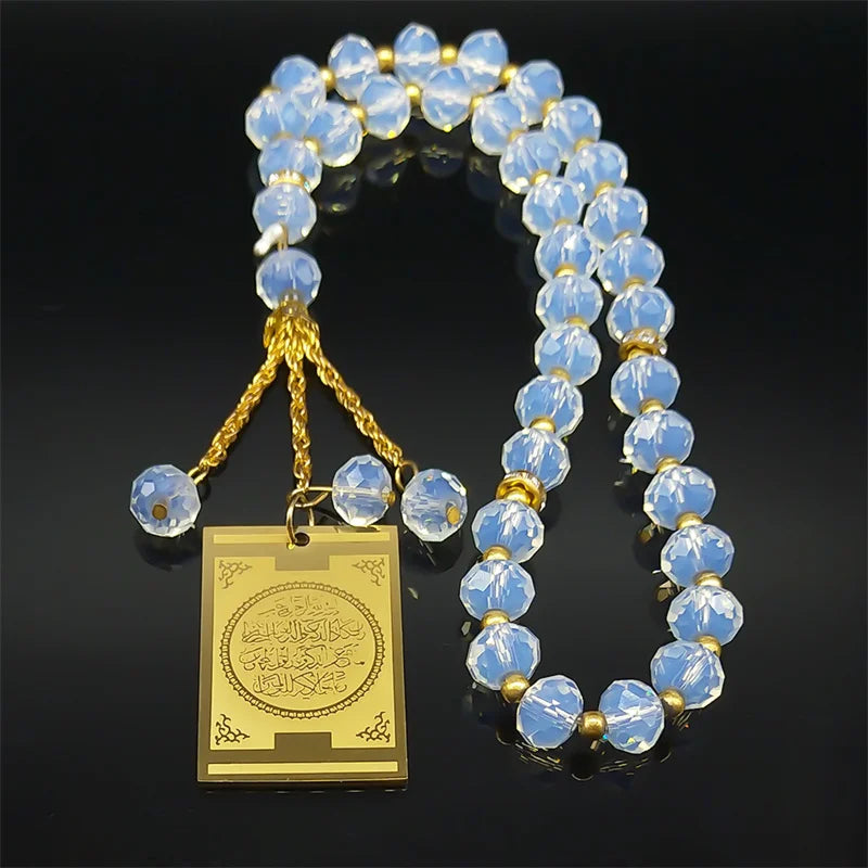 A gold-colored stainless steel pendant featuring a string of clear blue glass beads shaped like pearls.