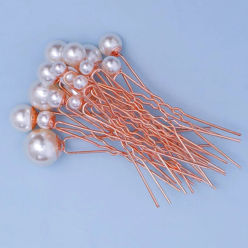 A cluster of 18 faux pearl hair pins with thin metal wires arranged on a light blue background.