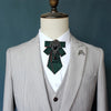 A light gray tailored suit jacket displayed on a mannequin with a dark green tie featuring diamond embellishments.