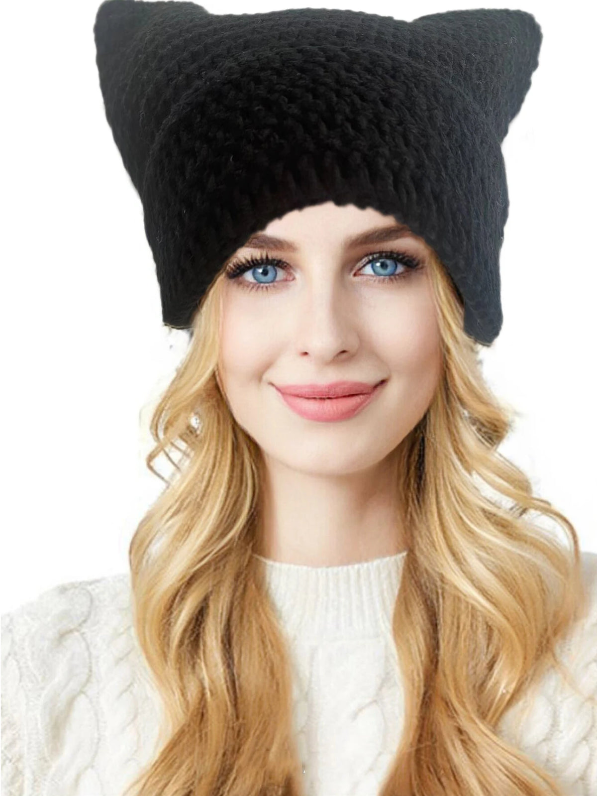 A woman models a black crocheted cat ears beanie hat with long blonde hair and a white sweater.