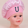 Pink satin sleep cap with a U letter design for a baby