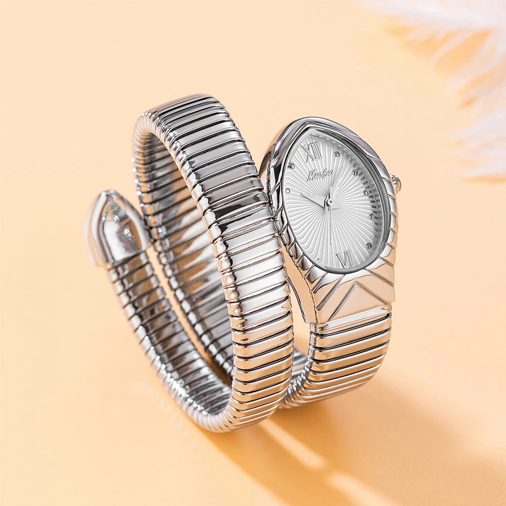 A silver quartz watch with a snake design on the band is shown on a light background.
