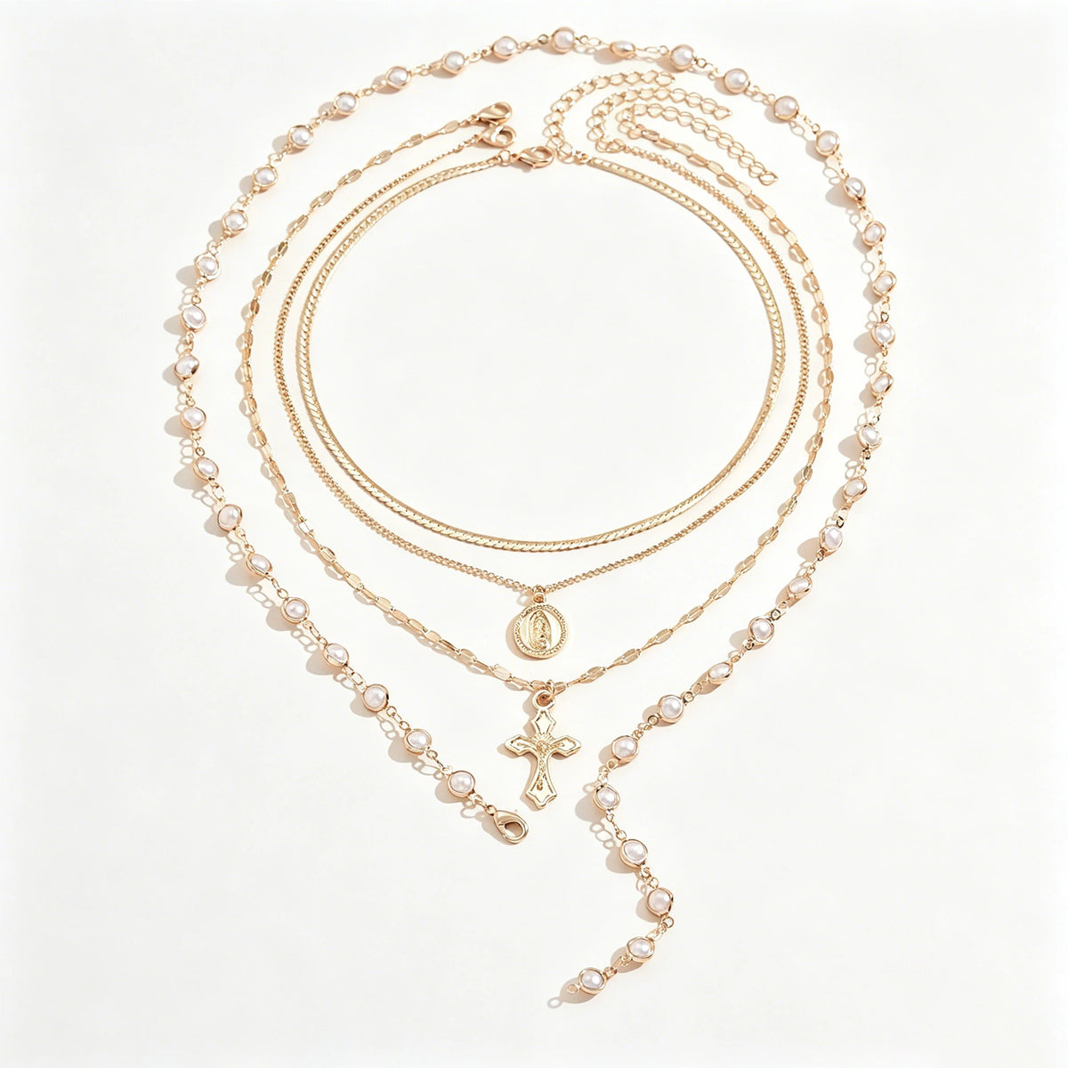 A delicate gold layered necklace featuring pearls and a cross pendant.