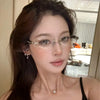 A close-up portrait of a woman wearing retro diamond-edged anti-blue light glasses.