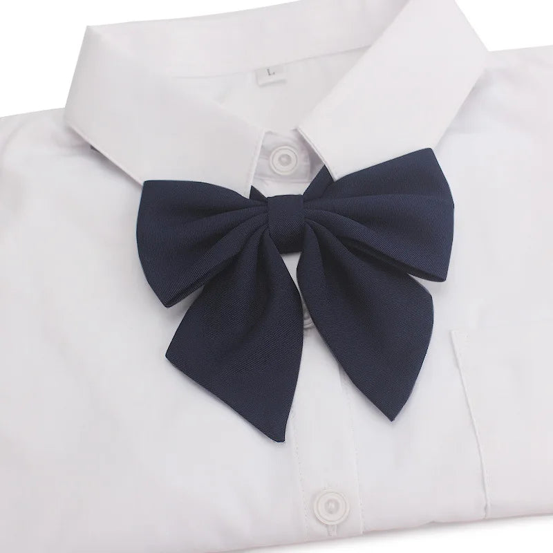 White collared shirt with a navy blue butterfly ribbon tie bow
