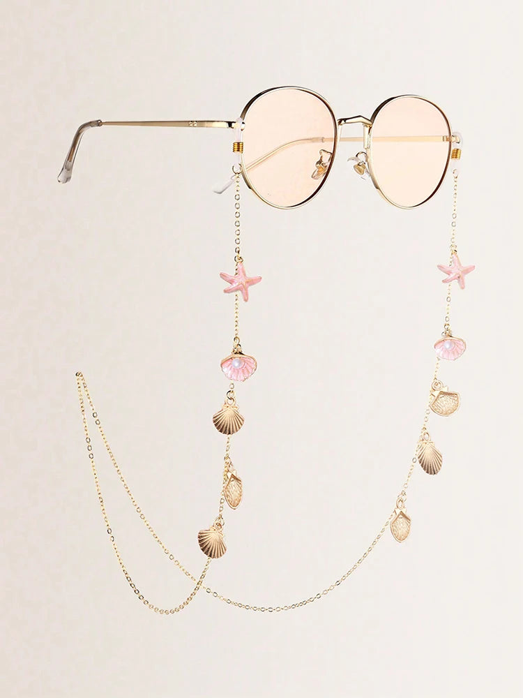 Lunettes en forme d'étoile de mer en métal élégantes avec une délicate chaîne dorée et des accents roses