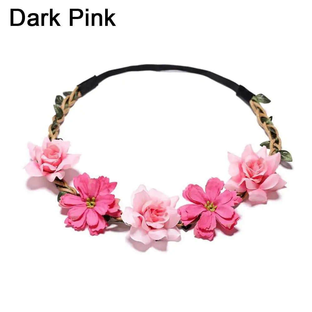 A dark pink bohemian flower headband featuring pink and green floral accents.