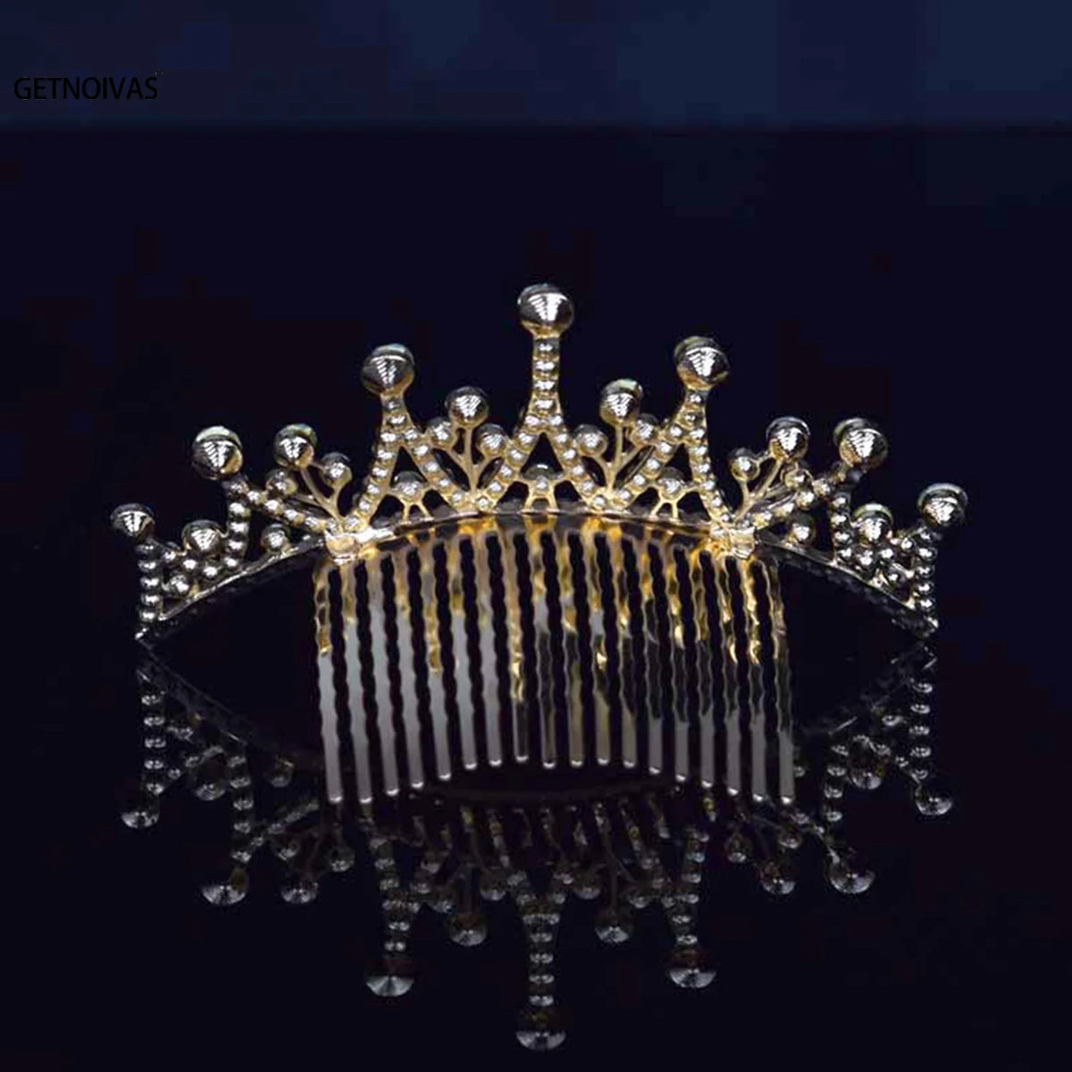 A sparkling crystal princess tiara hair comb for women displayed on a dark reflective surface.