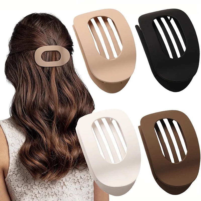 A set of flat circular hair clips in beige, black, and white shown alongside a woman's hair.
