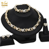 A gold heart crystal jewelry set featuring necklaces and earrings displayed on a black stand.