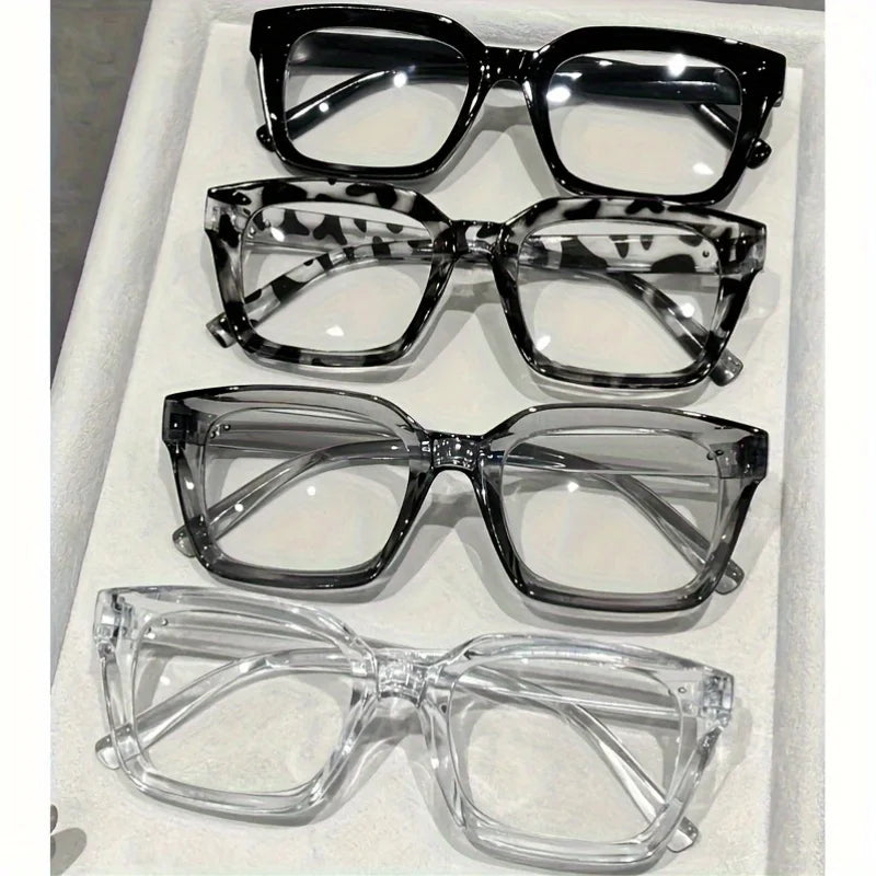 A display of five pairs of classic square reading glasses in various styles and colors.