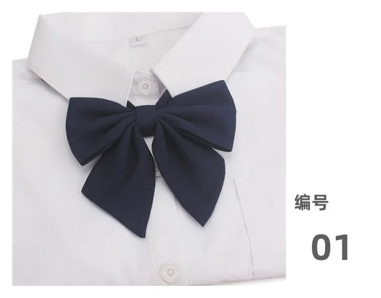 A navy blue butterfly ribbon tie set displayed on a white collared shirt.