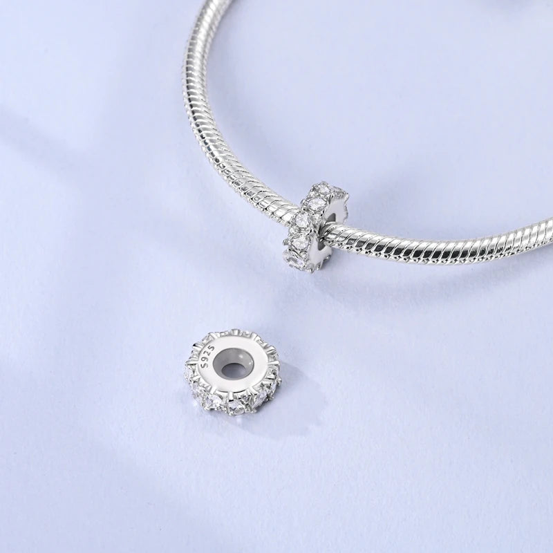 Sterling silver devil's eye charm bracelet with a textured chain and a round charm.