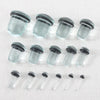 A row of clear glass ear stretching plugs or tunnels arranged horizontally.