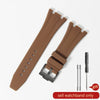A brown silicone watch band with a buckle and a separate pin is shown on a white background.