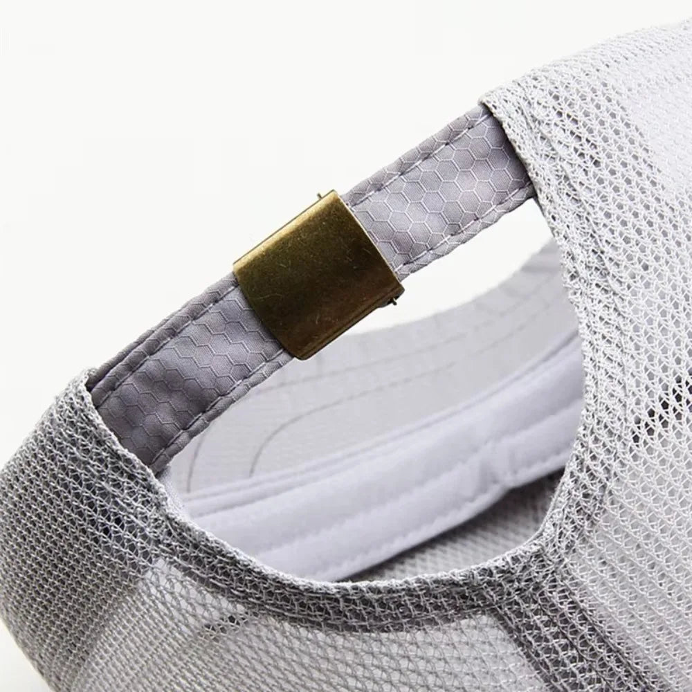 Gray mesh sun visor cap with a gold-colored adjustment strap visible on the side.