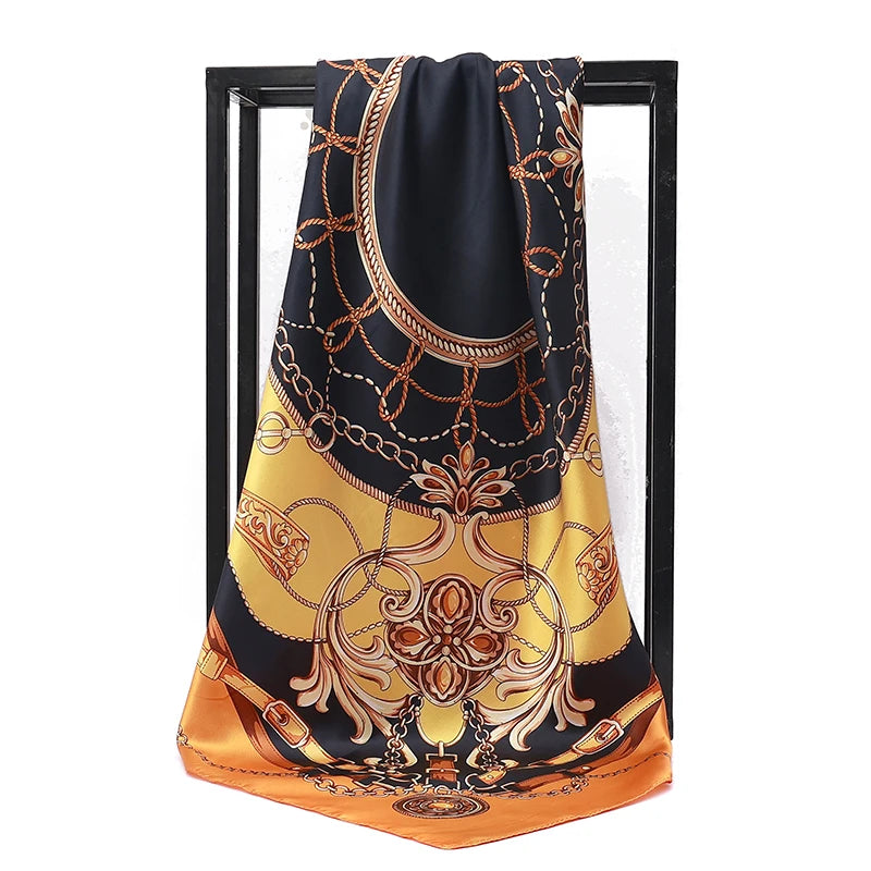A black silk print shawl with gold embroidery draped over a dark frame.
