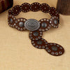 A brown leather waist belt decorated with oval metal studs and floral patterns.