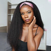 A woman with long black hair wearing a pink headband wig looking directly at the camera.