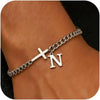 A close-up of a personalized stainless steel cross Cuban chain bracelet worn on a wrist.