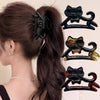 A set of three black and amber cat-shaped hair clips for hair decoration.