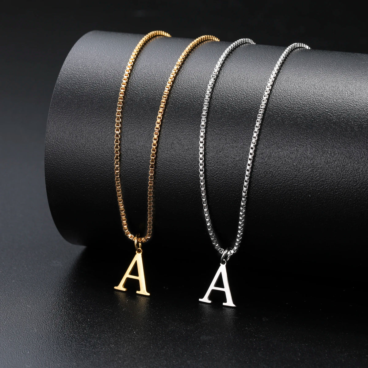 Two delicate necklaces featuring gold and silver initial letters A