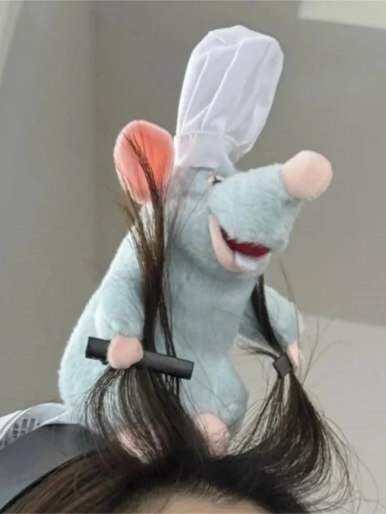 A light blue plush mouse face with pink ears and long black hair is shown as a hair accessory.