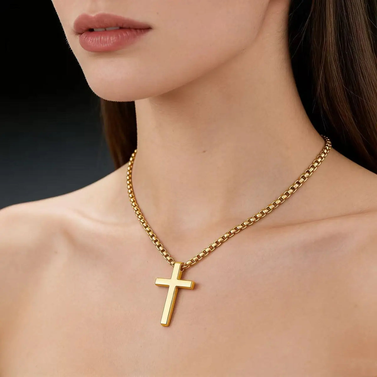 A close-up of a gold stainless steel cross pendant necklace worn around the neck against a light skin tone.