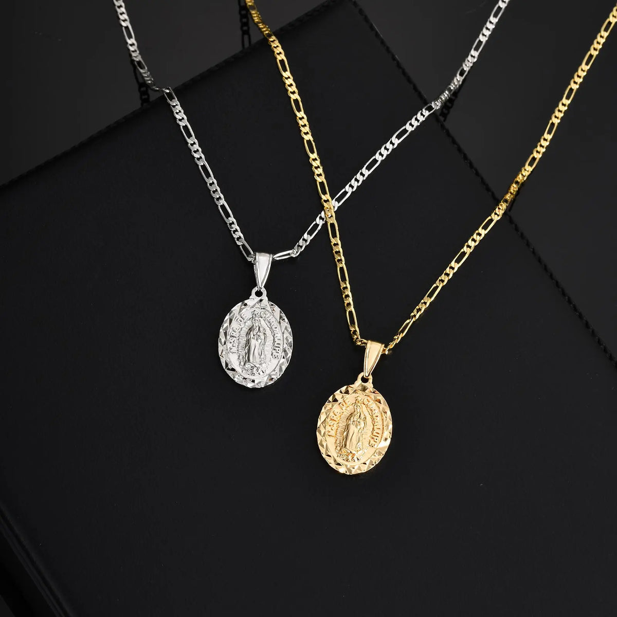 A gold and silver layered necklace featuring a Virgin Mary prayer pendant on a black background.
