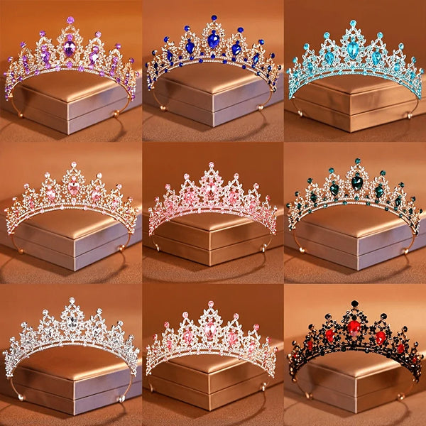 A collection of ornate crystal tiara headbands and crowns displayed on square boxes.