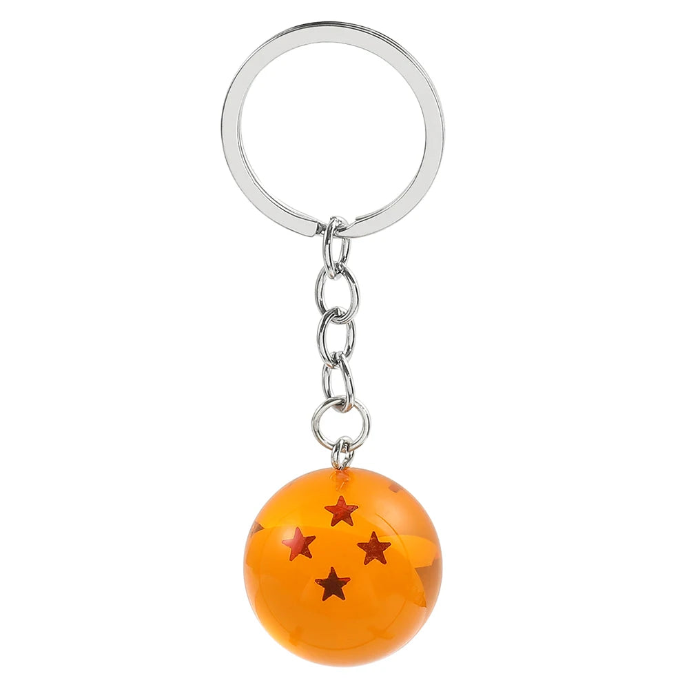 Silver hoop keychain with an orange spherical charm decorated with gold stars