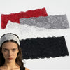 A woman models a black floral lace hair headband against a white background.